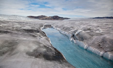 Dirty ice surrounds a meltwater stream near the margin of the Greenland ice sheet.