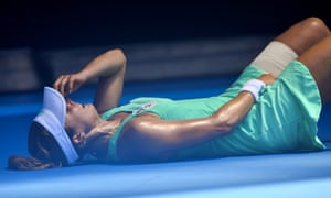 France’s Alize Cornet falls to the court after suffering from the heat during her third round match at the Australian Open tennis championships.