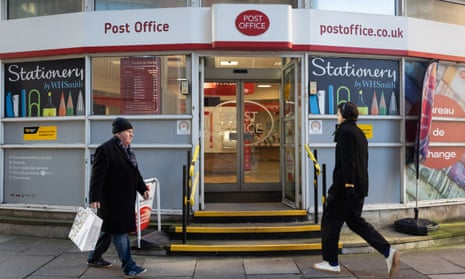 People walk past a post office in Westminster, London