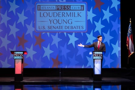 Jon Ossoff gestures to an empty lectern during a debate