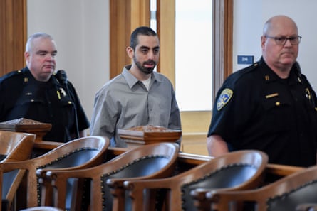 Police escort a man into court