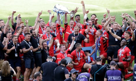 Vincent Koch and Liam Williams of Saracens lift the trophy as the celebrations continue.
