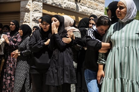 Mourners react during the funeral of Israeli Arab Khalil Awaad and his daughter Nadine, 16, in the village of Dahmash near the Israeli city of Lod, after a rocket fired from Gaza Strip hit their house and killed both father and his daughter.