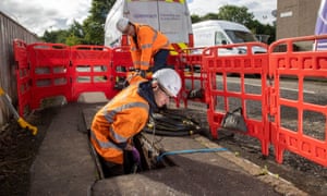 Two broadband engineers installing cables