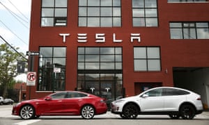 Two Tesla vehicles parked outside the company’s headquarters.