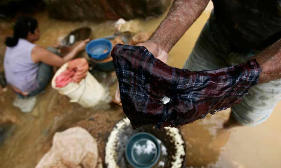 An artisanal miner shows mercury used for processing gold in southern Honduras