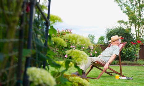 Older man napping in lawn chair in backyard