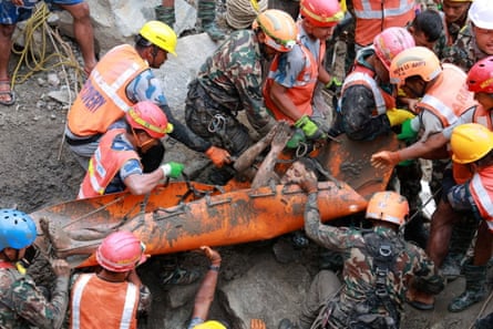 A survivor is carried out after being rescued from inside a tunnel