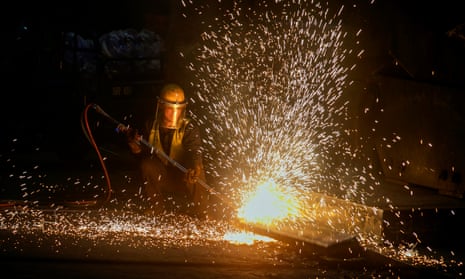 A worker welds the joint of a steel product at a factory of Jiangxi