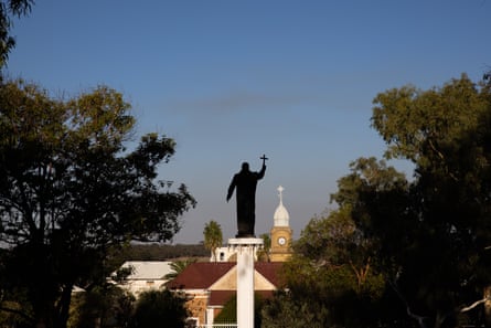 A view over New Norcia with a church statue holding up a cross in the centre