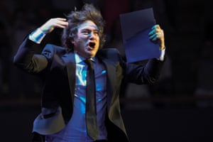 Javier Milei gestures as he walks on to the stage