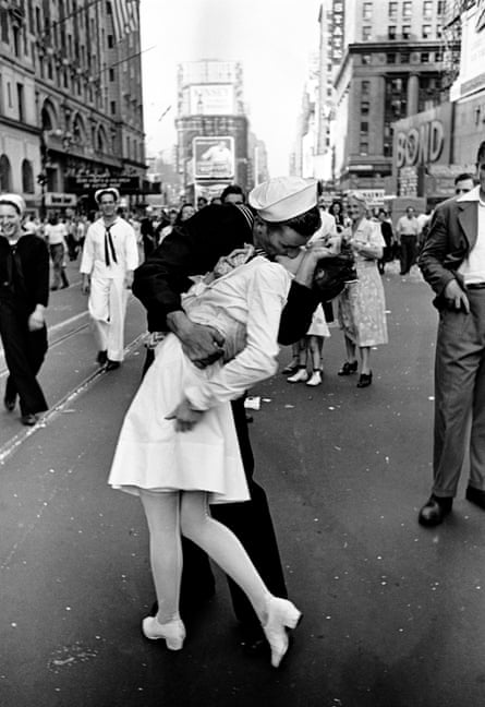 Black and white image of a sailor kissing a woman in a white uniform win New York City’s Times Square on August 14, 1945, following the news of Japan’s surrender in World War II