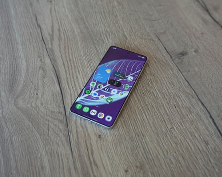 The Samsung Galaxy S25 Edge showing the home screen laying on a table.