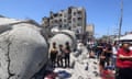 Palestinians perform Friday prayers next to the ruins of al-Farouq mosque in Rafah
