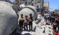 Palestinians perform Friday prayers next to the ruins of al-Farouq mosque in Rafah