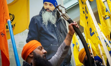 Protesters chant in front of a banner bearing an image of murdered Sikh activist Hardeep Singh Nijjar outside the Consulate General of India office in Vancouver, British Columbia.