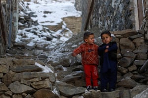 Kabul, Afghanistan. Two young boys chat on a snow-covered street on Koh-e Asamai