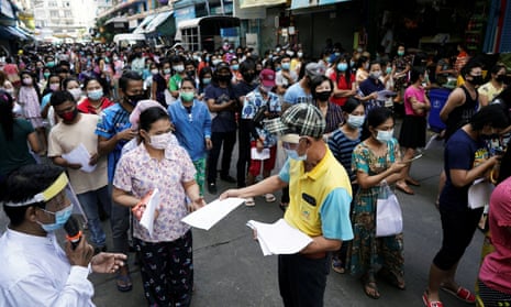 Migrant workers queue Covid tests in Samut Sakhon province, in Thailand, after an outbreak of cases connected to the Central Shrimp market.