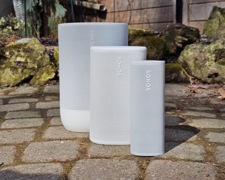 three speakers of varying sizes on ground outside