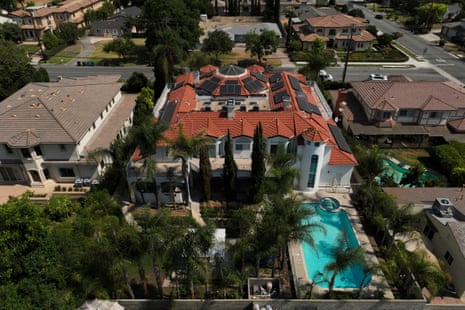 Aerial view of a large Arcadia home with solar panels, red roof tiles, and a swimming pool