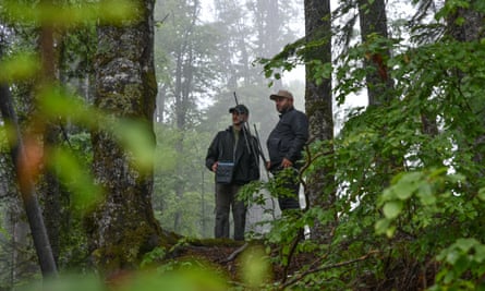 Two rangers track the bison herd.