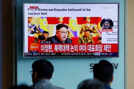 South Koreans watch a North Korean TV report on Friday.