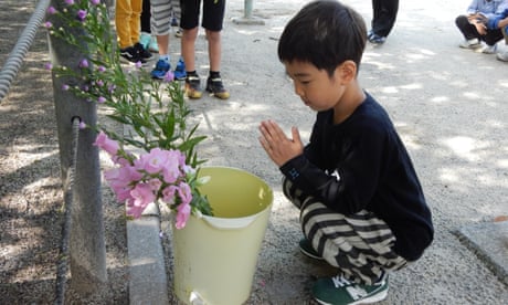 Students honour the A-bomb victims during a peace memorial ceremony at Shiroyama Elementary School in Nagasaki.