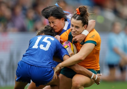 The Australia wing Maya Stewart is tackled by the Samoa full-back Karla Wright-Akeli (left) and wing Drenna Falaniko (top).