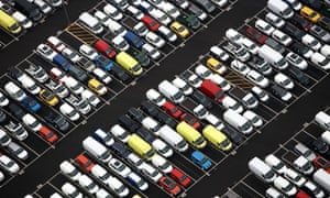 Rows of new automobiles and vans, including Jeep Cherokee SUV automobiles, sit parked at the Port of Bristol.
