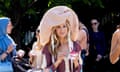 Sarah Jessica Parker looking lost in her own inner world in oversized gingham hat with people around