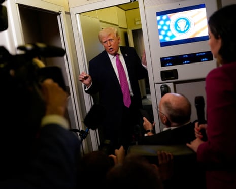 Donald Trump talks to the media aboard Air Force One on Sunday