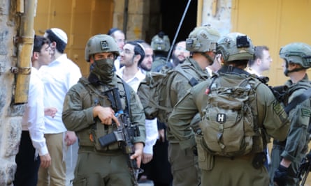 Israeli forces are deployed as Jewish settlers stage a provocative march around the old town in Hebron, West Bank, in July 2024.