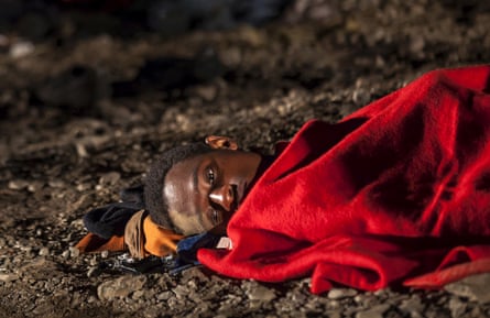 An African migrant rests after arriving on a fishing boat at Las Carpinteras beach in the Canary Island of Gran Canaria, Spain, September 1, 2015