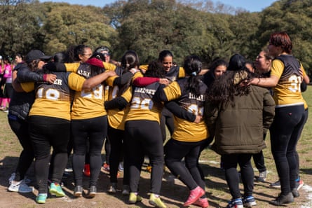 A kickingball team huddle in the Olympic Park, Buenos Aires.