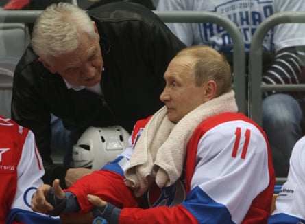 Vladimir Putin listens to Gennady Timchenko during a hockey match at Black Sea resort of Sochi in May 2017