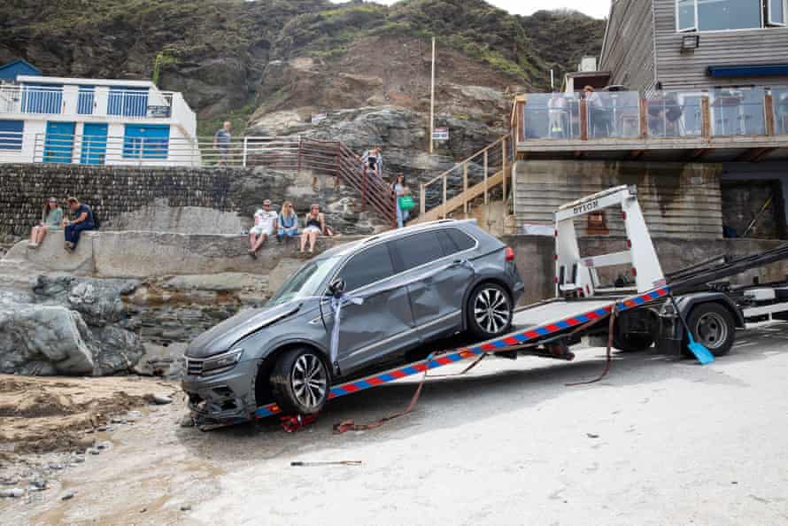The car being dragged onto a recovery trailer.