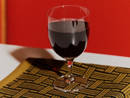 A large glass of red wine on a bistro table