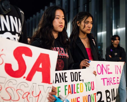 Cornell University students hold protest signs.