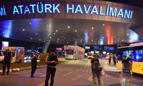 Policemen stand guard at the entrance to Ataturk International Airport in Istanbul, Turkey.