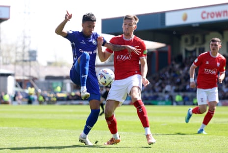 Rochdale’s Kyron Gordon (left) is challenged by York’s Mark Kitching at the Crown Oil Arena.