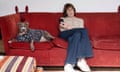 Zoe Williams and dog on a red sofa
