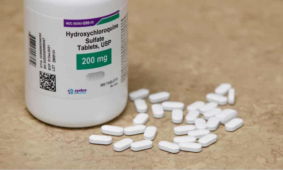 A bottle and pills of hydroxychloroquine as they sit on a counter.