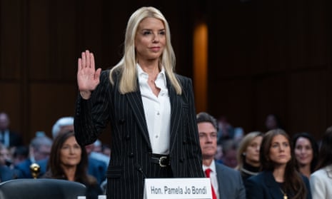 A woman stands and holds one hand up