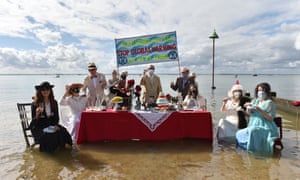 Activists held a Titanic-themed dinner party at Chalkwell beach, Southend-on-Sea, on 31 August to highlight rising sea levels.