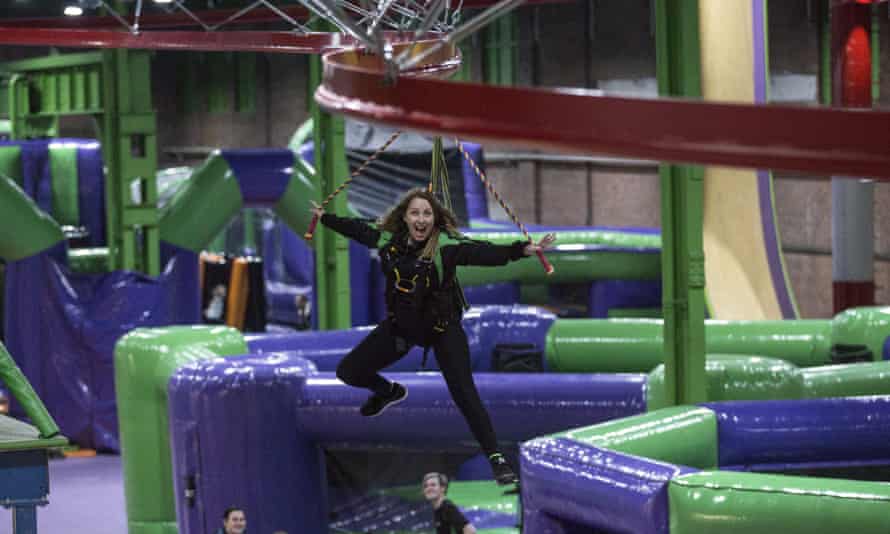 Woman swings from bouncy objects at Inflatspace, Newcastle, UK.
