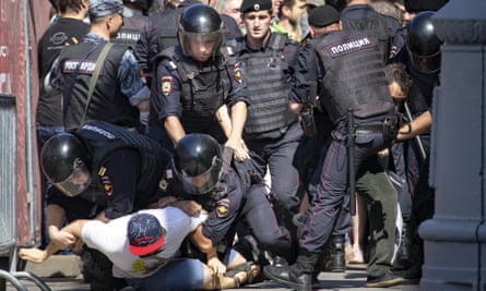 Police officers detain protesters during an unsanctioned rally in Moscow on Saturday.