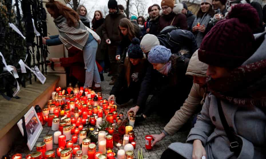 People light candles in memory of the journalist Ján Kuciak and his partner, Martina Kusnirova, in Prague.