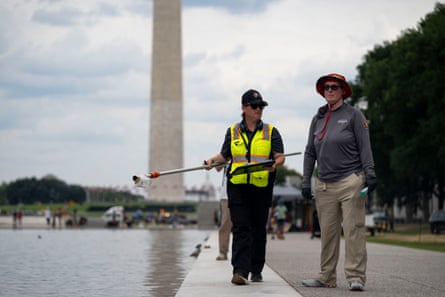 Workers stand by the reflecting pool