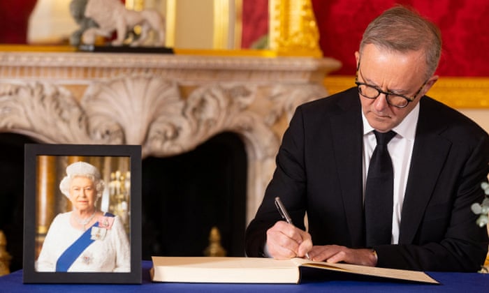 Anthony Albanese signs a book of condolence at Lancaster House in London.