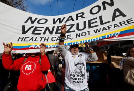 Demonstrators marched down Market Street to United Nations Plaza in San Francisco to protest against Trump’s military actions in Venezuela, on Saturday.